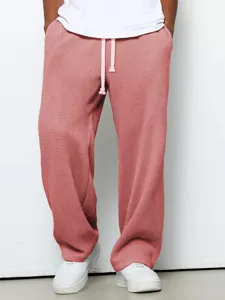 Loose waffle knit casual trousers for men and women, comfortable streetwear sweatpants detail.