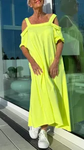Vue de détail de la longue robe ample jaune néon à épaules dénudées pour la saison.