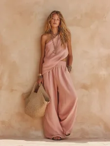 Pink linen-like asymmetric one-shoulder top and wide-leg pants set, detail view of casual outfit.