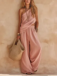 Detail view of stylish pink linen one-shoulder top and wide-leg trousers set for women.