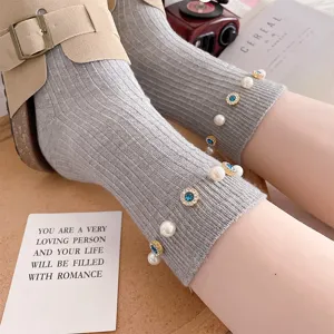 Women grey mid-calf socks featuring elegant pearls and blue rhinestone floral embellishments.