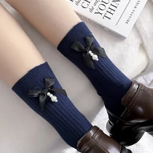 Navy blue knit mid-calf socks with black bow and pearl charm, cute Harajuku style.