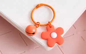 Detailopname van Oranje bloem sleutelhanger, snoepkleurige metalen ring met een leuk belletje.