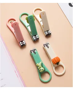 Detailed view of cute cartoon nail clippers in assorted colors with fun dinosaur and pumpkin designs.