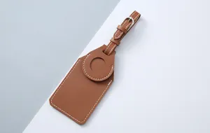 Brown PU leather luggage tag detail view, protective case for Apple AirTag tracking device.