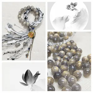 Close-up detail of grey resin cat eye beads and handmade bracelet accessories, smooth surface texture.