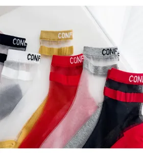 Close-up view of sheer crystal socks with striped cuffs and stylish letter details for daily wear.
