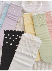 Detail view of women pearl ruffle socks in candy colors. Trendy sweet mid-tube style.