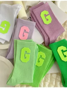 Women ribbed crew socks with letter G patch, trendy Korean style spring summer casual socks.