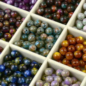 Close-up detail of colorful resin oil painting round beads for DIY handmade jewelry making.