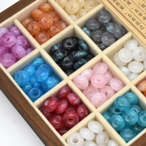 Detailed view of sparkly resin beads with glitter effects, neatly arranged in compartments for DIY.