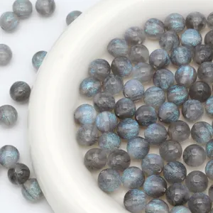 Detailed view of grey round beads with blue shimmer for DIY jewelry and phone chain accessories.