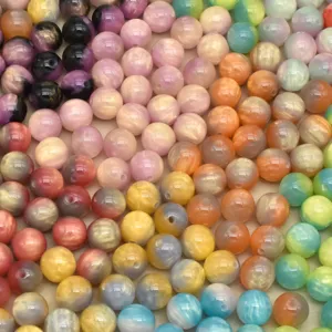 Colorful resin loose beads detail showing tie-dye swirled pattern for DIY jewelry making.