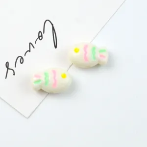 Close-up detail shot of colorful painted acrylic fish beads, perfect for DIY jewelry craft.