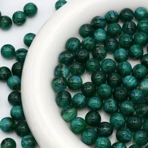 Close up view of dark green glitter loose round beads, perfect for DIY jewelry making details.