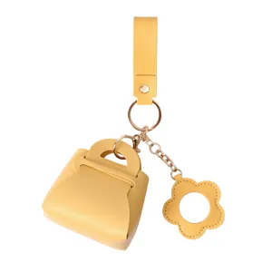 Yellow PU leather mini handbag keychain with cute flower charm, stylish bag pendant accessory.
