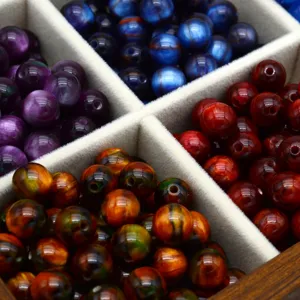 Close-up of colorful cat eye loose beads, oil painting style gradient bead details for DIY jewelry.