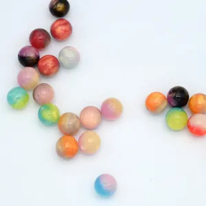Detailed close-up of colorful resin beads with gradient marbling effect for diy jewelry.
