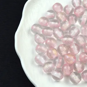 Close-up detail of 16mm pink glitter resin beads, perfect for DIY jewelry and crafts.