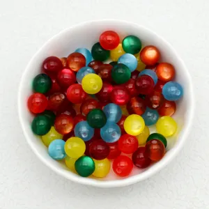 Close-up detail view of colorful jelly-color resin cat's eye loose beads for DIY handmade bracelets.