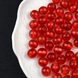 Red glitter resin beads detail shot, perfect for DIY jewelry crafting, phone charms and bracelets.