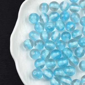 Close-up detail of light blue glitter resin beads showcasing sparkly starry texture for DIY.
