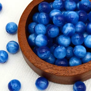 Blue swirled cat eye beads detail shot, perfect for DIY handmade jewelry bracelets necklaces.