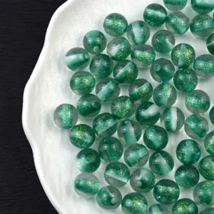 Detail shot of 16mm green glitter resin cat-eye beads, perfect for DIY handmade jewelry crafts.