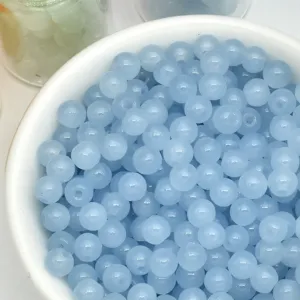Close-up detail of light blue 4mm loose beads, perfect for DIY handmade jewelry and bracelet making.