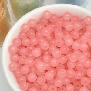 Close-up detail of 4mm pink loose beads in white bowl, perfect for DIY handmade jewelry.