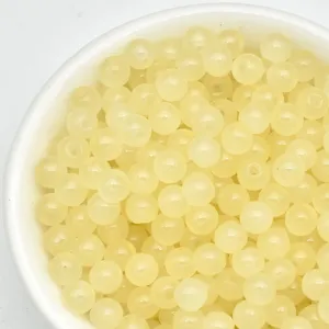 Close-up detail of light yellow 4mm loose beads, perfect for handmade DIY jewelry making.