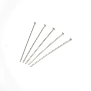 Silver tone metal flat head pins for DIY jewelry making, beading accessories detail view.