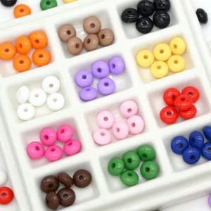 Colorful spacer beads detailed view, sorted in grid tray, perfect for DIY jewelry making.