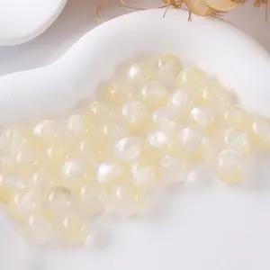 Close-up detail of Milky white glitter resin round beads for DIY jewelry making accessories.