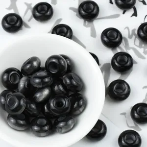 Detail shot of black imitation cat eye abacus resin beads for DIY jewelry and hair accessories.