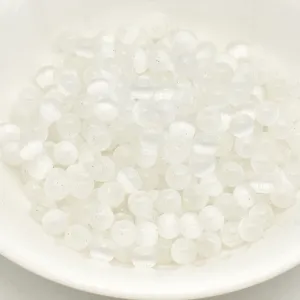 Close-up detail of white cat's eye glass beads, perfect for DIY jewelry and phone chain making.