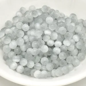 Close-up detail of grey cat eye glass beads, round spacer beads for handmade DIY jewelry.