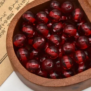 Close-up detail of red imitation amber resin round beads, perfect for DIY jewelry making.
