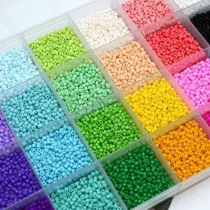 Detailed close-up of vibrant multi-color glass seed beads neatly sorted in a clear storage box.
