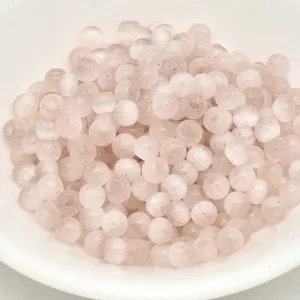 Close-up of 4mm pink cat-eye glass seed beads, ideal for DIY handmade bracelets and crafts.