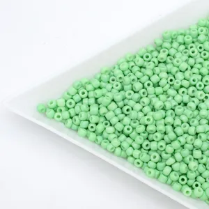 Light green glass seed beads detail close up, perfect for DIY handmade beaded jewelry.