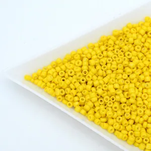 Close-up detail view of vibrant yellow glass seed beads for crafting jewelry parts