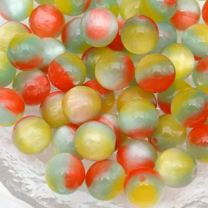 Close-up of colorful resin cat-eye round beads, smooth glossy finish for DIY jewelry crafting.