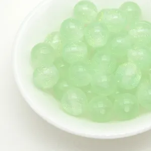 Light green glitter resin round beads detail shot, perfect for DIY jewelry making and crafts.