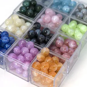 Detailed view of colorful glitter resin loose beads in clear boxes, perfect for DIY jewelry making.