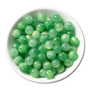 Green resin cat's eye round bead detail closeup, perfect for DIY handmade jewelry accessories.