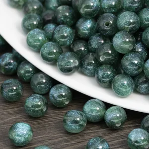 Green glitter resin round beads for DIY jewelry making, ideal for handmade necklaces and bracelets.