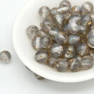 Close-up detail of grey translucent resin beads featuring gold foil flakes and fine glitter.