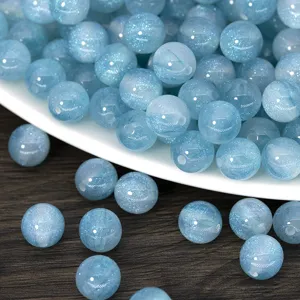 Blue glitter resin round beads detail shot, sparkling DIY loose beads for jewelry making accessories.