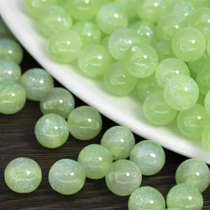 Light green glitter resin round beads for DIY handmade jewelry bracelets necklaces crafting.